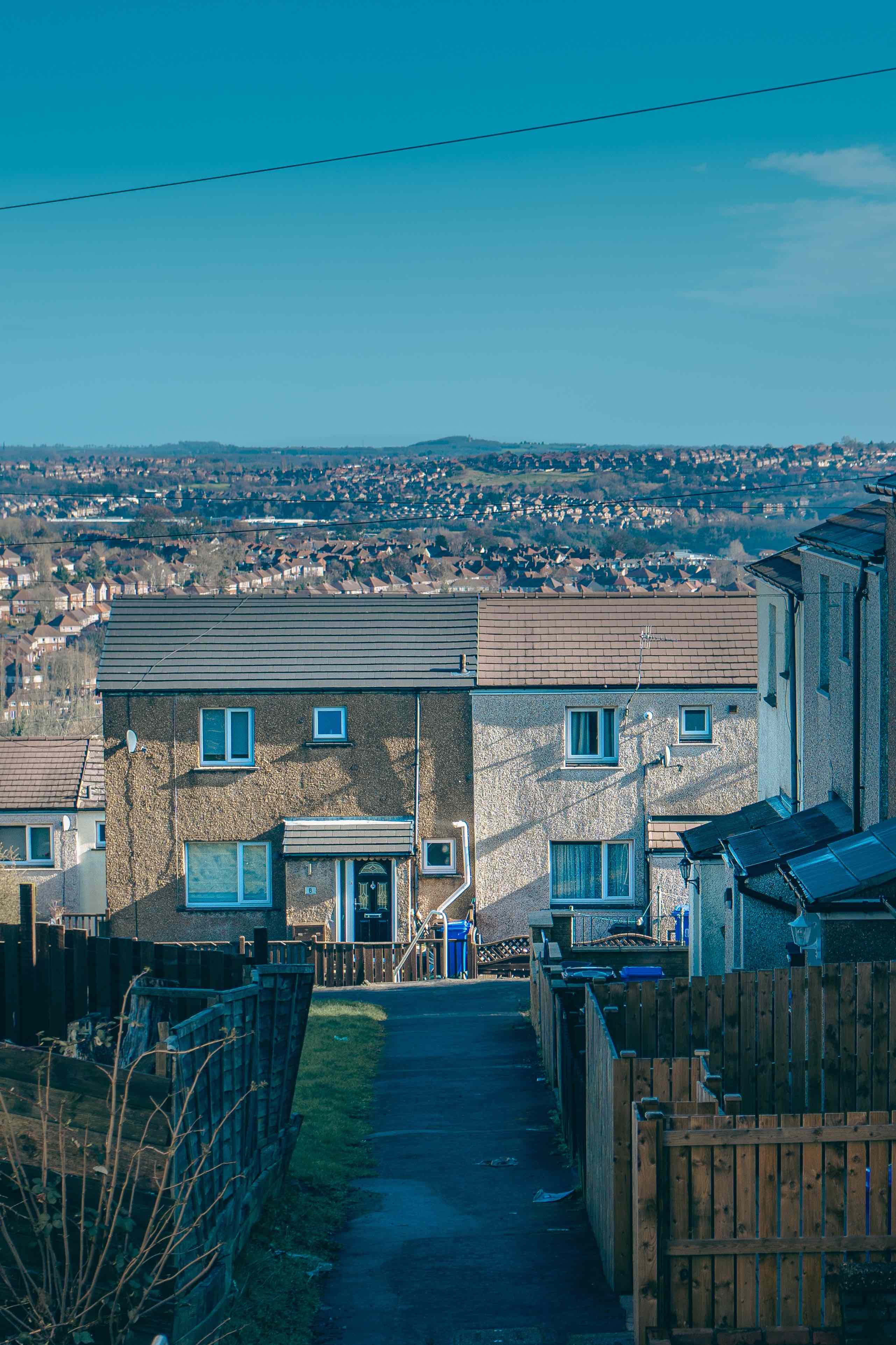 Arlen Hill Council Housing - Standing Row Area with two semi-detached homes shown and Arlen Hill in background.